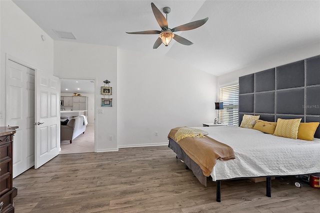 11287 Stewart Loop, Oxford, FL 34484 - bedroom with lofted ceiling, wood finished floors, a ceiling fan, and baseboards