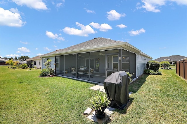 11287 Stewart Loop, Oxford, FL 34484 - back of house featuring a sunroom, a yard, a ceiling fan, and a shingled roof