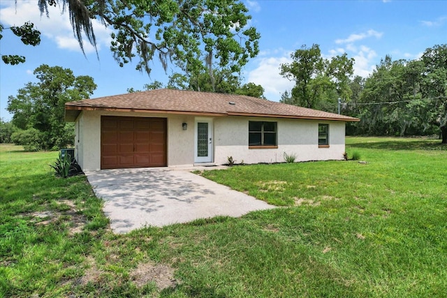 10655 N Party Ave, Dunnellon, FL 34433 - ranch-style house with stucco siding, a garage, a front lawn, and driveway