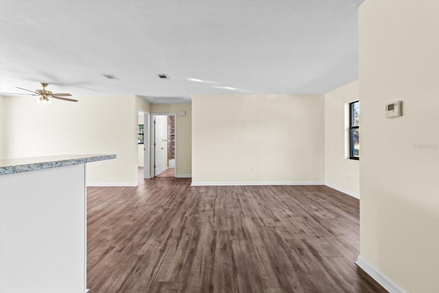 10655 N Party Ave, Dunnellon, FL 34433 - empty room featuring dark wood-style flooring, baseboards, and ceiling fan