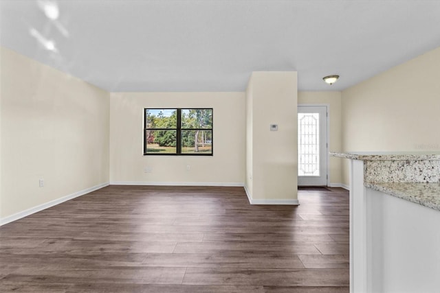 10655 N Party Ave, Dunnellon, FL 34433 - empty room featuring healthy amount of natural light, dark wood-style floors, and baseboards