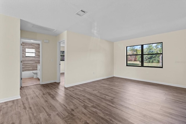 10655 N Party Ave, Dunnellon, FL 34433 - spare room with wood finished floors, baseboards, and attic access