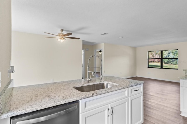10655 N Party Ave, Dunnellon, FL 34433 - kitchen with dishwasher, a sink, white cabinetry, a ceiling fan, and light stone countertops