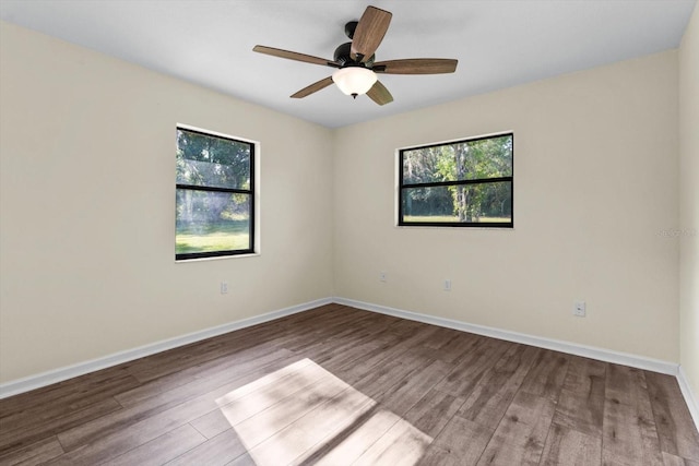 10655 N Party Ave, Dunnellon, FL 34433 - empty room with plenty of natural light, wood finished floors, a ceiling fan, and baseboards