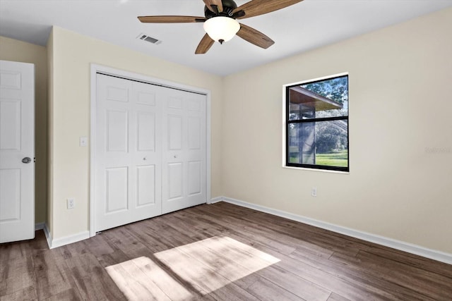10655 N Party Ave, Dunnellon, FL 34433 - unfurnished bedroom featuring wood finished floors, baseboards, a closet, and ceiling fan