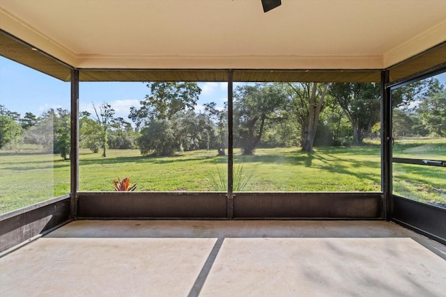 10655 N Party Ave, Dunnellon, FL 34433 - unfurnished sunroom featuring view of wooded area and healthy amount of natural light