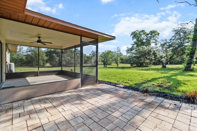 10655 N Party Ave, Dunnellon, FL 34433 - view of patio featuring a ceiling fan, a sunroom, and view of wooded area