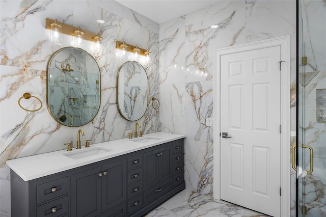 full bath with a marble finish shower, marble tiled flooring, double vanity, and tile walls