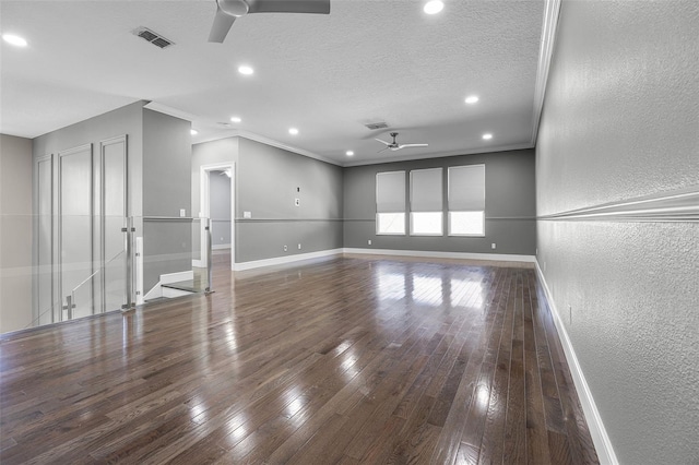 spare room featuring ceiling fan, a textured wall, crown molding, baseboards, and recessed lighting