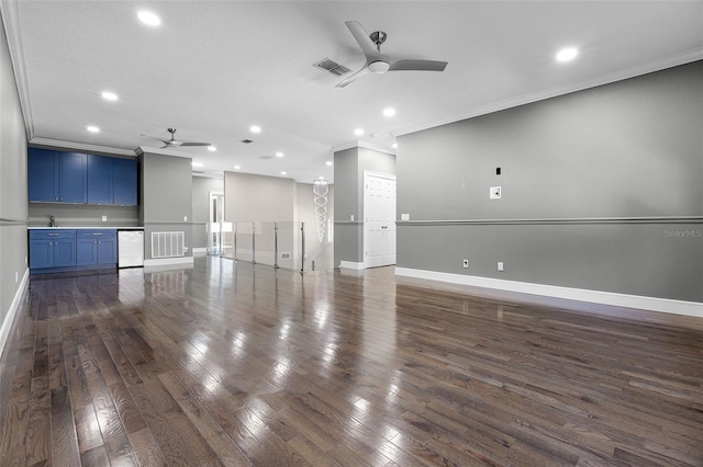 unfurnished living room with a ceiling fan, crown molding, recessed lighting, baseboards, and dark wood finished floors