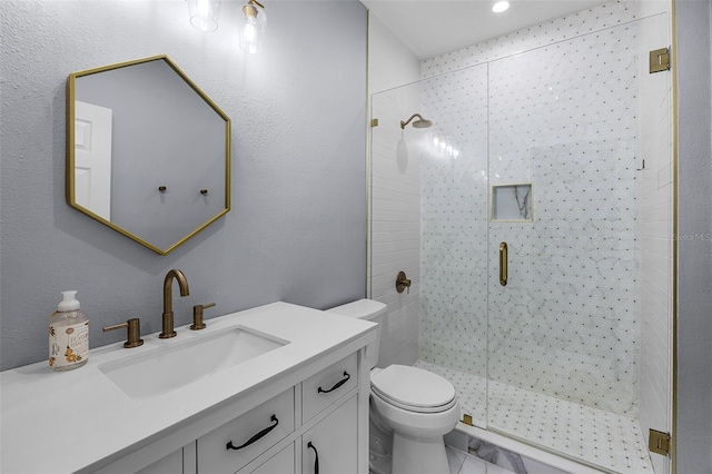 bathroom with a stall shower, toilet, vanity, and recessed lighting