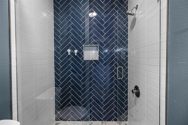 bathroom with a shower stall