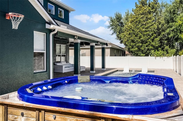 view of pool featuring a hot tub and a fenced backyard