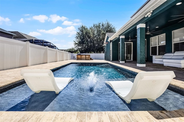 view of pool with a fenced backyard, a ceiling fan, and a patio