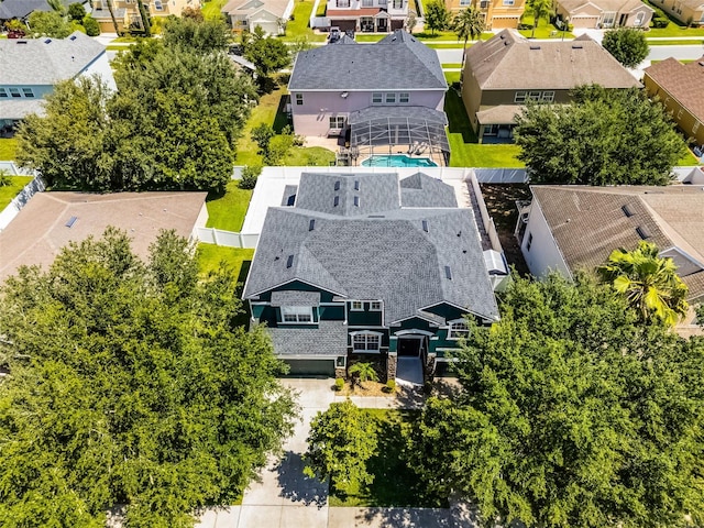 aerial perspective of suburban area featuring a pool