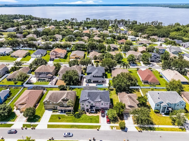 aerial perspective of suburban area with a nearby body of water