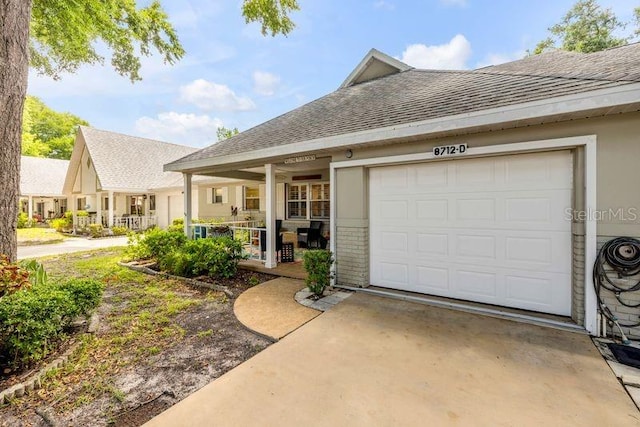 view of front of home with a shingled roof, concrete driveway, and a garage