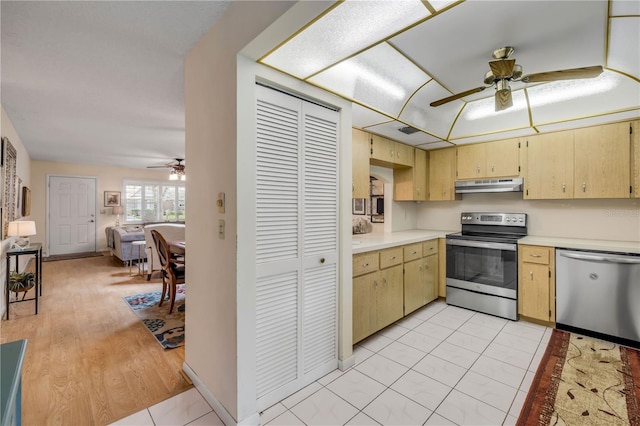 kitchen featuring appliances with stainless steel finishes, ceiling fan, under cabinet range hood, light countertops, and open floor plan
