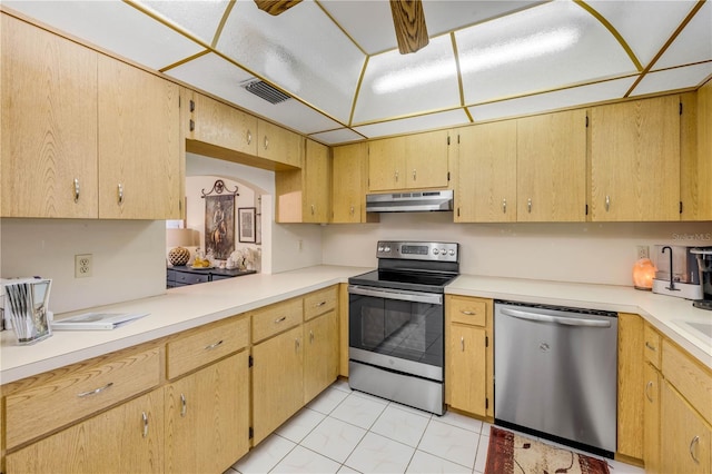 kitchen with stainless steel appliances, under cabinet range hood, and light countertops