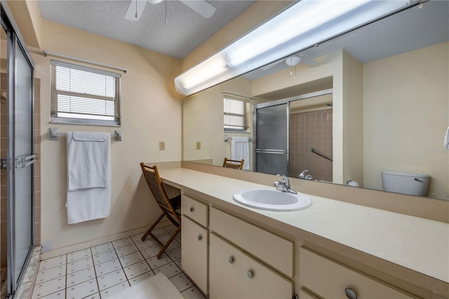 full bathroom featuring ceiling fan, healthy amount of natural light, a stall shower, and tile patterned floors