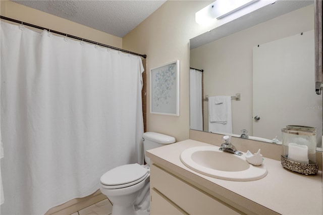 bathroom with a textured ceiling, toilet, and vanity