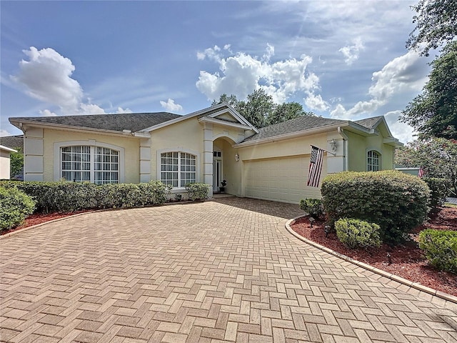 2415 Twickingham Ct, Clermont, FL 34711 - single story home featuring stucco siding, decorative driveway, and an attached garage