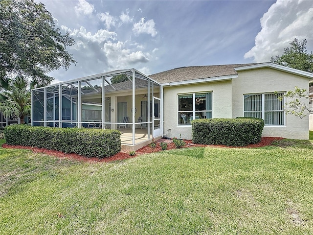 2415 Twickingham Ct, Clermont, FL 34711 - back of property featuring stucco siding, a lawn, and a lanai