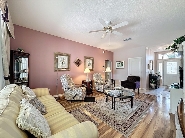2415 Twickingham Ct, Clermont, FL 34711 - living room featuring ceiling fan, a textured ceiling, wood finished floors, and baseboards
