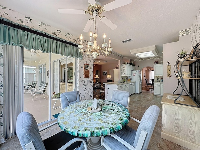 2415 Twickingham Ct, Clermont, FL 34711 - dining area with a ceiling fan, arched walkways, and a chandelier