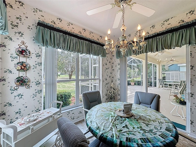 2415 Twickingham Ct, Clermont, FL 34711 - dining space featuring wallpapered walls, a ceiling fan, a chandelier, and baseboards
