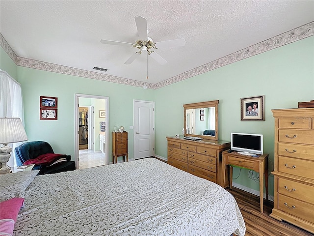2415 Twickingham Ct, Clermont, FL 34711 - bedroom featuring wood finished floors, a textured ceiling, and ceiling fan
