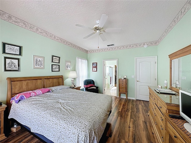 2415 Twickingham Ct, Clermont, FL 34711 - bedroom with dark wood-style floors, a textured ceiling, and a ceiling fan