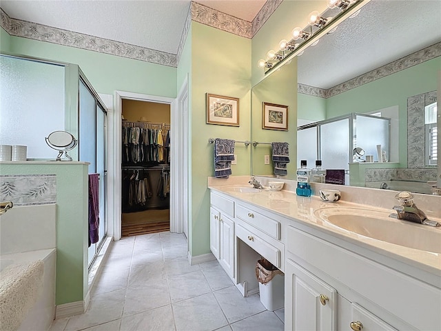 2415 Twickingham Ct, Clermont, FL 34711 - bathroom featuring a stall shower, a bath, a textured ceiling, double vanity, and tile patterned floors
