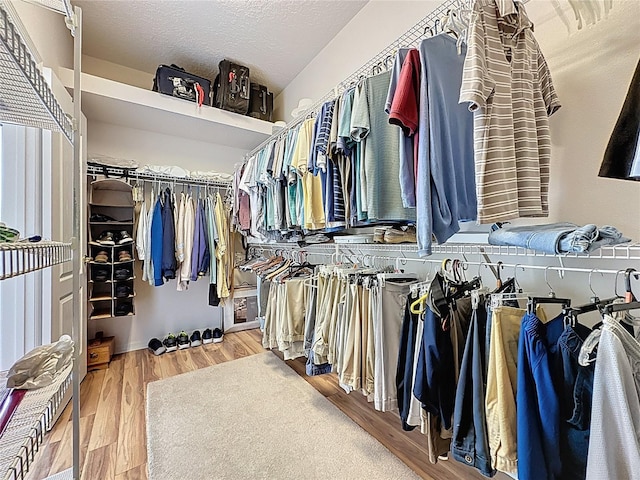 2415 Twickingham Ct, Clermont, FL 34711 - walk in closet featuring wood finished floors