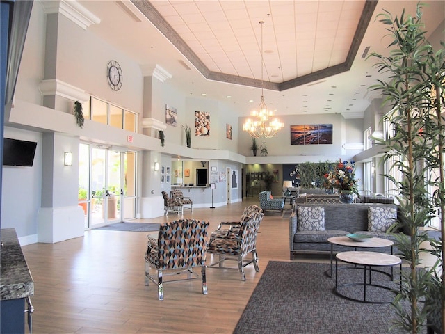 2415 Twickingham Ct, Clermont, FL 34711 - dining space with a raised ceiling, a chandelier, wood finished floors, and a high ceiling