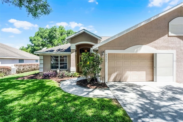 8527 Firestone Cir, Clermont, FL 34711 - ranch-style home with stucco siding, an attached garage, driveway, and a front yard
