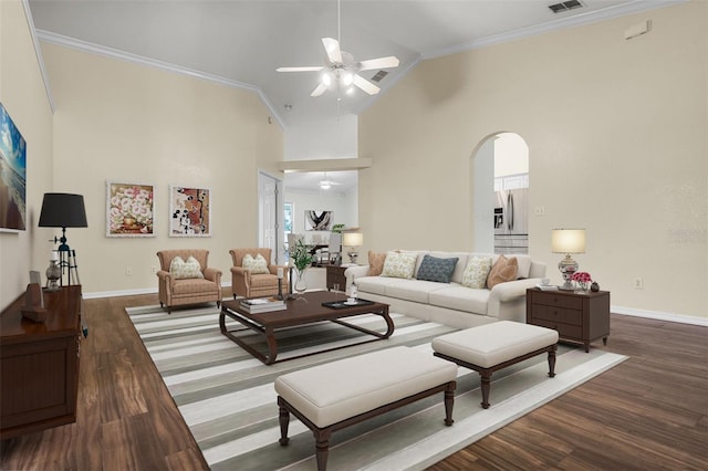8527 Firestone Cir, Clermont, FL 34711 - living room with a ceiling fan, arched walkways, crown molding, wood finished floors, and baseboards