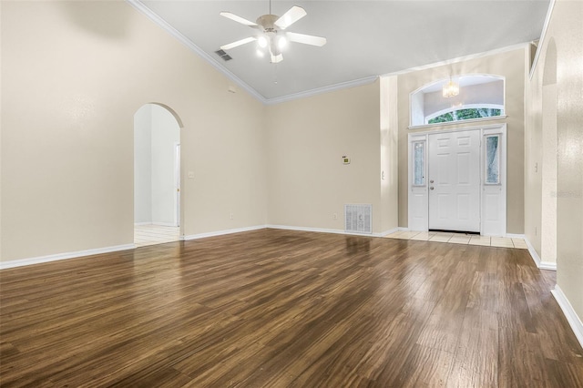 8527 Firestone Cir, Clermont, FL 34711 - foyer featuring arched walkways, wood finished floors, ornamental molding, ceiling fan, and vaulted ceiling