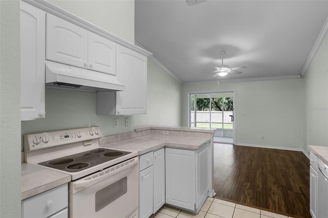 8527 Firestone Cir, Clermont, FL 34711 - kitchen with electric range, under cabinet range hood, ornamental molding, white cabinets, and a peninsula