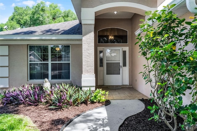 8527 Firestone Cir, Clermont, FL 34711 - doorway to property featuring stucco siding and a shingled roof