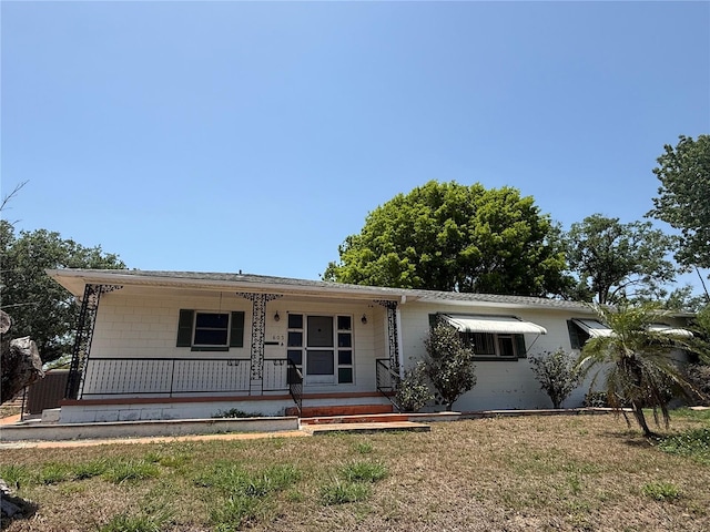 603 W Seminole Ave, Eustis, FL 32726 - single story home featuring a porch, concrete block siding, and a front yard