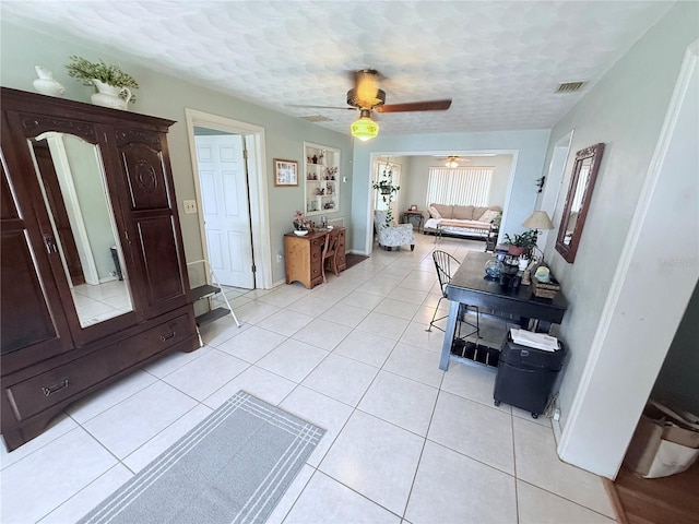 603 W Seminole Ave, Eustis, FL 32726 - dining room with light tile patterned floors, a ceiling fan, and baseboards