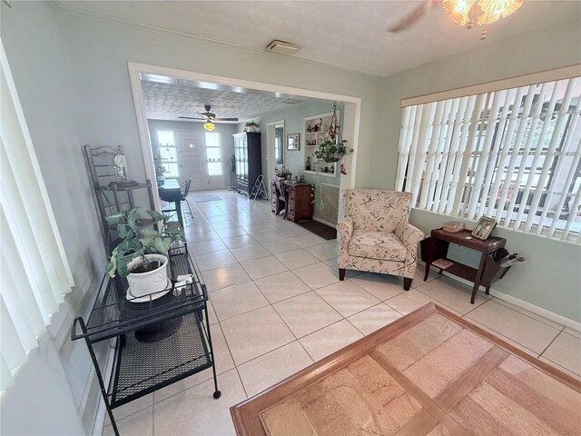 603 W Seminole Ave, Eustis, FL 32726 - living area with a ceiling fan, light tile patterned floors, and baseboards