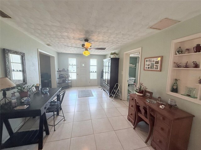 603 W Seminole Ave, Eustis, FL 32726 - entrance foyer featuring a textured ceiling, light tile patterned flooring, and a ceiling fan