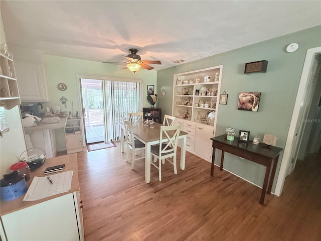 603 W Seminole Ave, Eustis, FL 32726 - dining room featuring light wood-type flooring and a ceiling fan