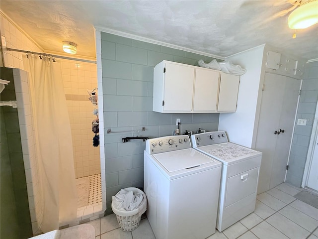 603 W Seminole Ave, Eustis, FL 32726 - clothes washing area with independent washer and dryer, light tile patterned floors, crown molding, cabinet space, and tile walls
