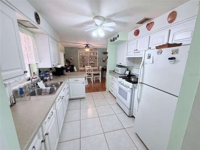 603 W Seminole Ave, Eustis, FL 32726 - kitchen featuring white appliances, under cabinet range hood, ceiling fan, and white cabinetry