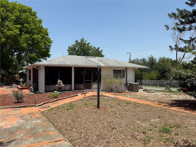 603 W Seminole Ave, Eustis, FL 32726 - view of front of property featuring a sunroom, cooling unit, fence, and a patio area