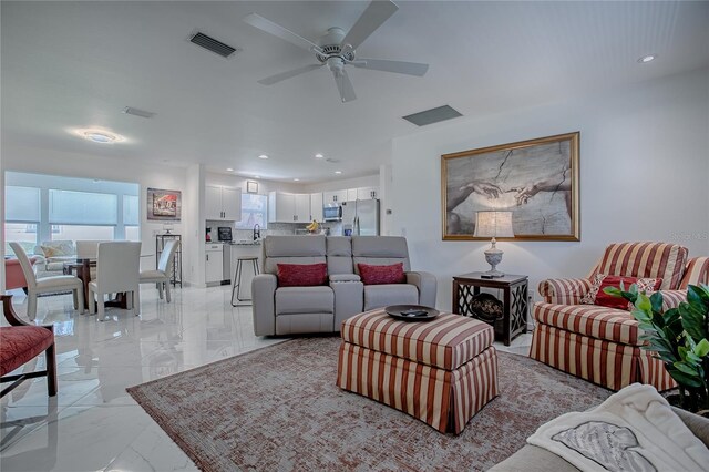 17009 SE 96th Chapelwood Cir, The Villages, FL 32162 - living area featuring light marble finish floors, ceiling fan, and recessed lighting