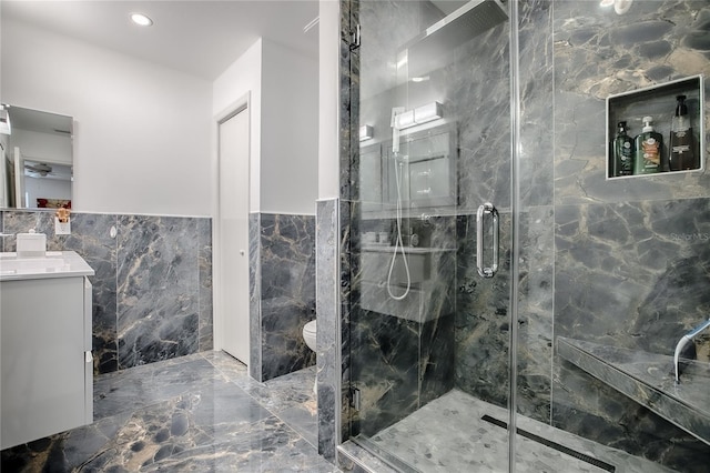 17009 SE 96th Chapelwood Cir, The Villages, FL 32162 - full bath featuring tile walls, marble tiled floors, a marble finish shower, vanity, and wainscoting